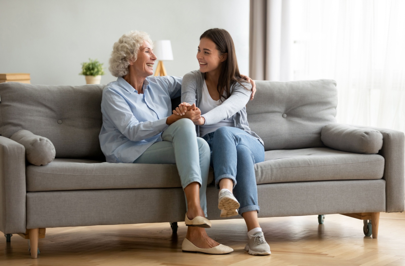 An adult child has a warm discussion with their senior parent about memory care in the future.