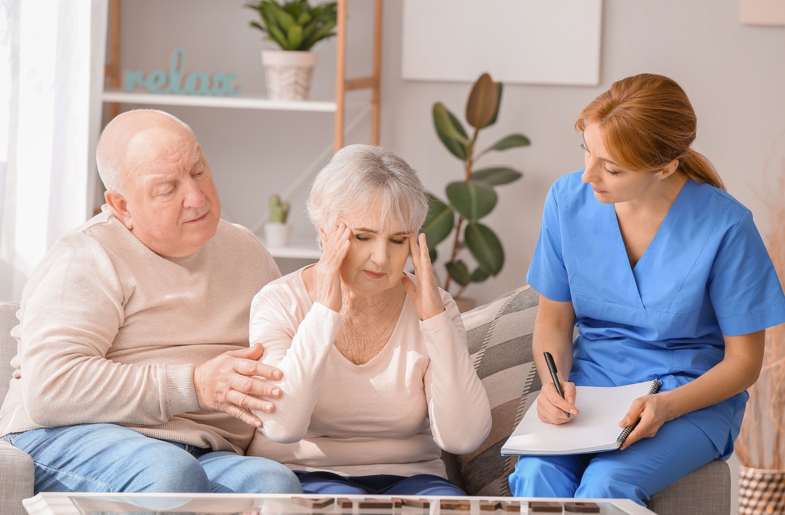 A senior couple meet with a healthcare advisor to help run through the FAST Scale to get advice on memory issues